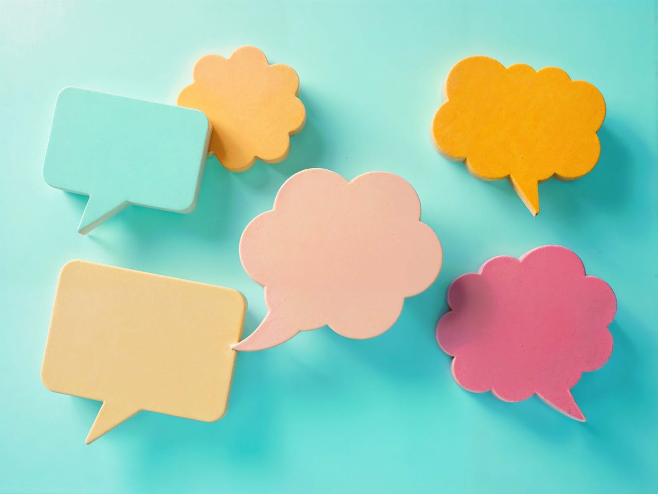 services-02 Bright pastel speech bubbles on a blue background, ideal for communication themes.