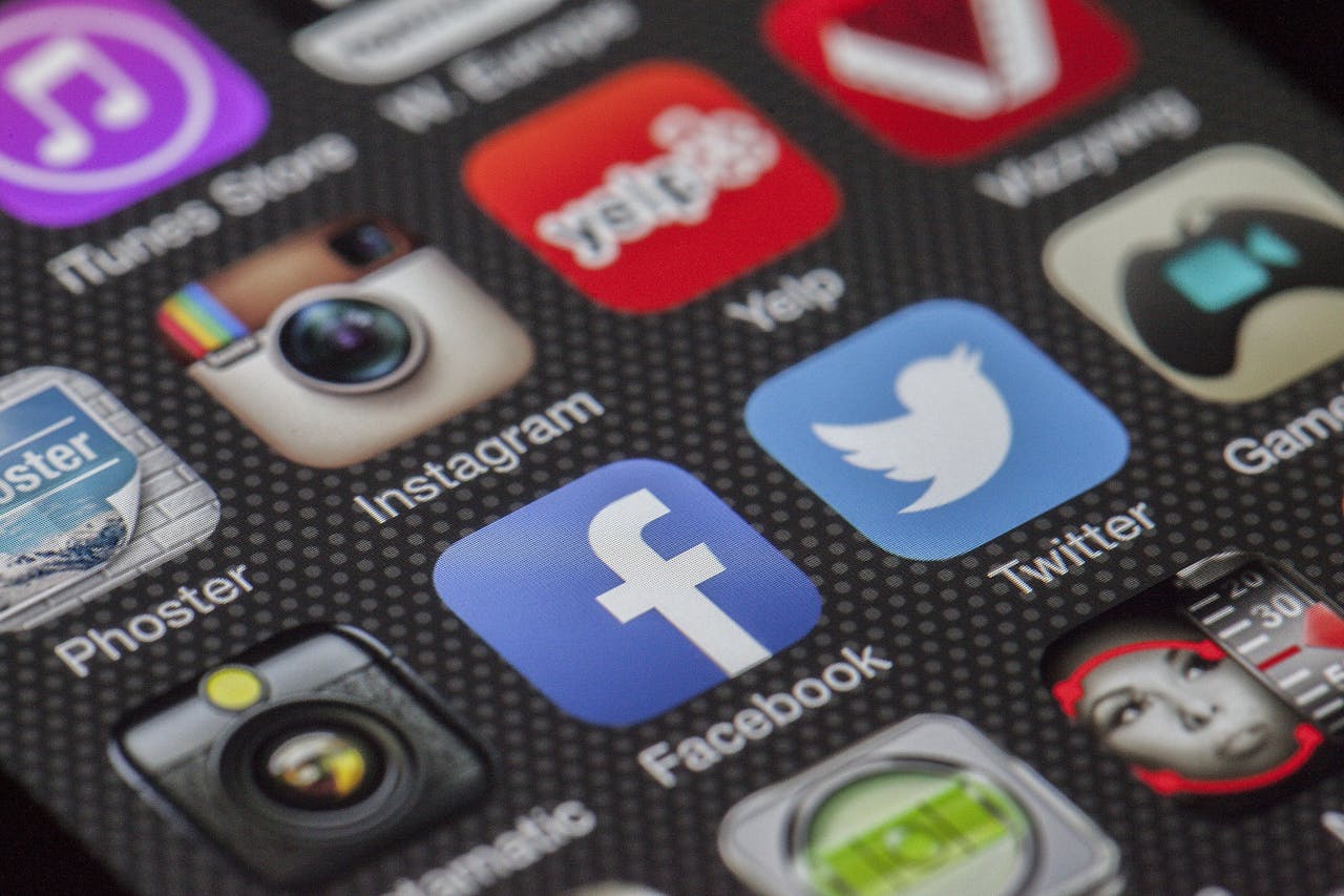 journey Close-up image of various social media app icons on a smartphone screen.